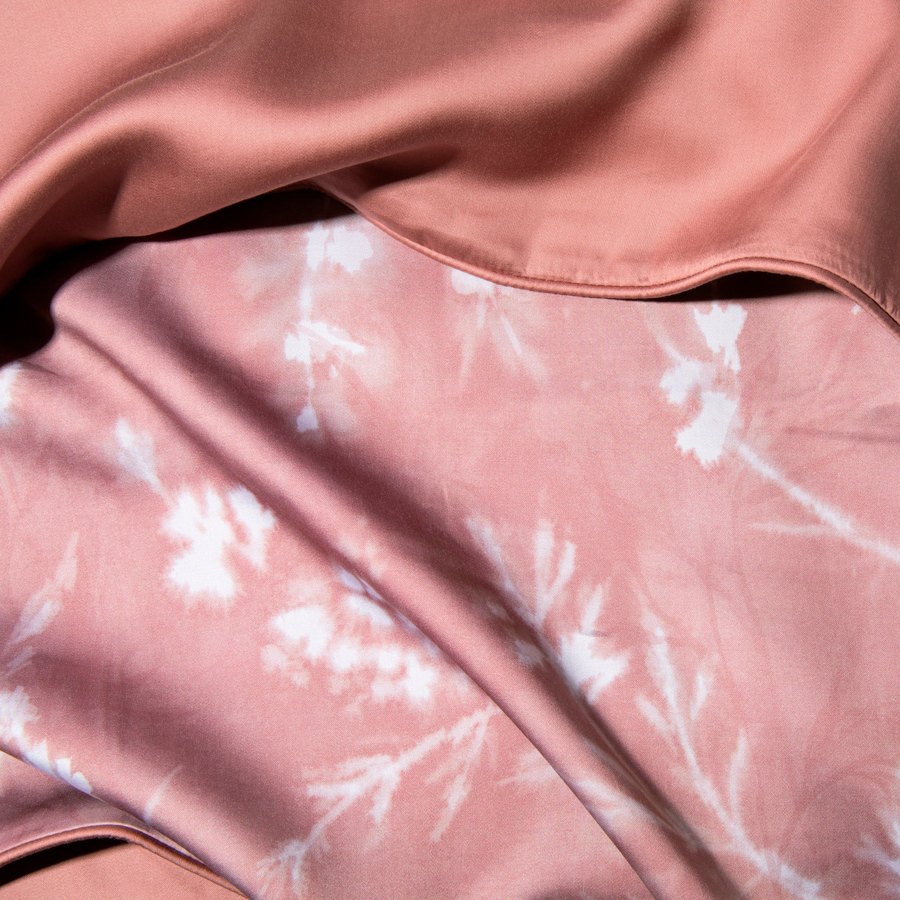 Close-up image of the Floral Ash Rose Pillow Shams + Cooling showcasing both the Floral Ash Rose side and the reversible plain Ash Rose side