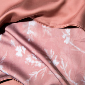 Close-up image of the Floral Ash Rose Pillow Shams + Cooling showcasing both the Floral Ash Rose side and the reversible plain Ash Rose side